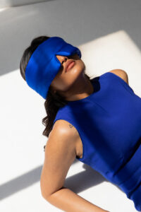 Drowsy Sleep Co. Royal Blue Silk Sleep Mask worn by a woman